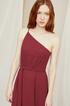 Captivating in flowing chiffon, this one-shoulder bridesmaid dress is accented with delicate ruching and tied at the waist above an airy skirt.