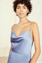 Drape neckline with low back, fit-to-flare dress with slit in fluid satin.