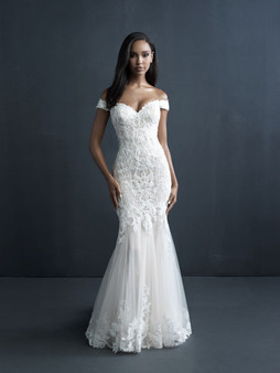 Dazzling detail work captures the eye in this off shoulder sheath.