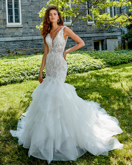 hand beaded lace v neckline, sheer bodice. Low back, Fit and Flare silhouette with whimsical skirt, chapel train with horsehair.
