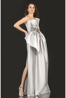 Three-dimensional sculptured bodice has a cascading flower and beads with oversized draped bow skirt.