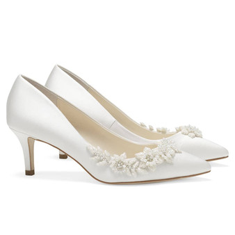 The perfect ivory or light blue heels wedding guests will admire, Iris Blue. These blue kitten heel wedding shoes embody tradition re-imagined and re-defined. Teardrop luminous pearls and ivory beads are embellished in the shape of flowers and vines sweeping the side of these blue kitten heels wedding shoes. The 3D ivory blooms and vines provide textural contrast to the soft blue silk. These blue low heels wedding occasion pieces provide comfort, tradition, and style.